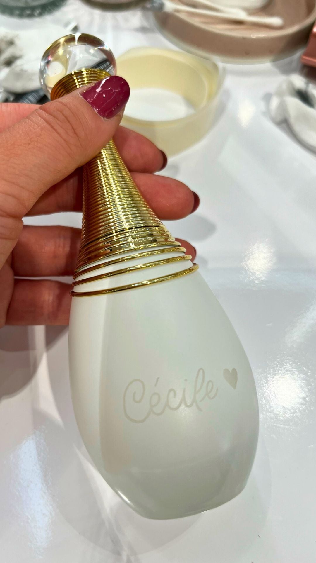 Photo d'une gravure sur parfum pour le prénom "Cecile" avec un coeur gravé à côté